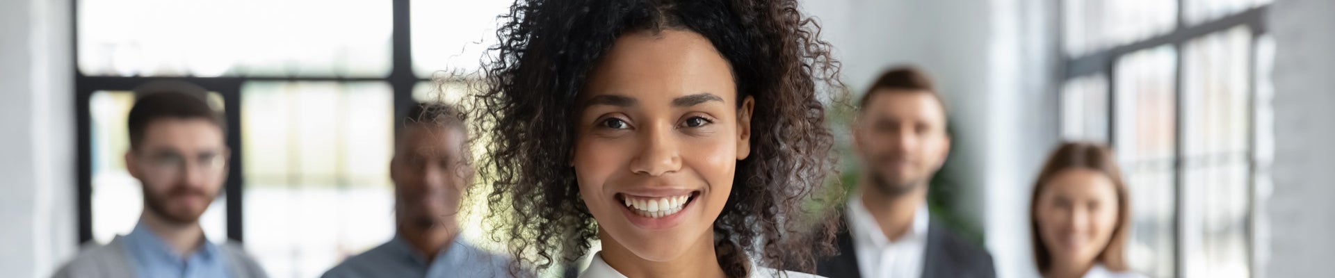Head shot portrait smiling African American businesswoman offering handshake, standing with extended hand in modern office, friendly hr manager or team leader greeting or welcoming new worker