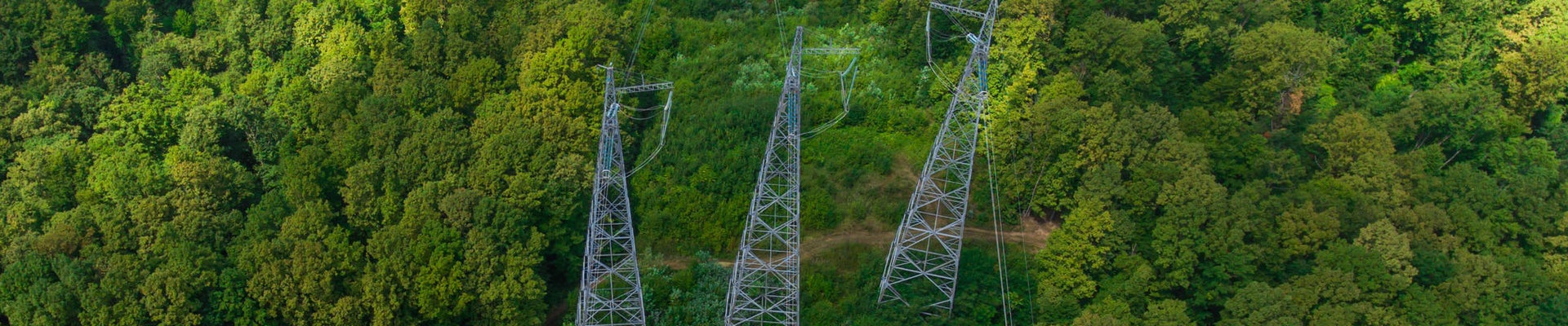 Aerial view. High voltage metal post. High-voltage towers in the forest.