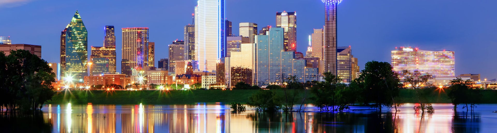 Downtown Dallas Texas reflects on the full Trinity River.