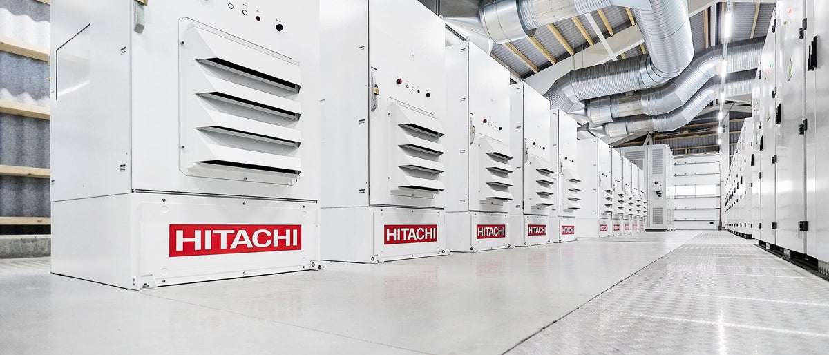 Crowded streets of Shinjuku shopping district with blurred commuters at dusk 