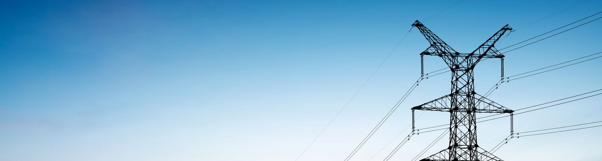 Pylon and transmission power line in sunset