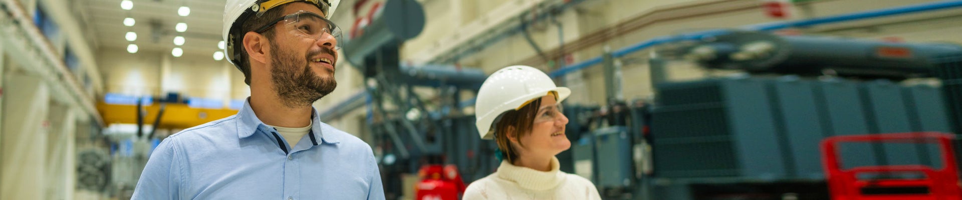 Young woman in an apron in a greenhouse conducts research into the growth of vegetables. Summer assignment for a student