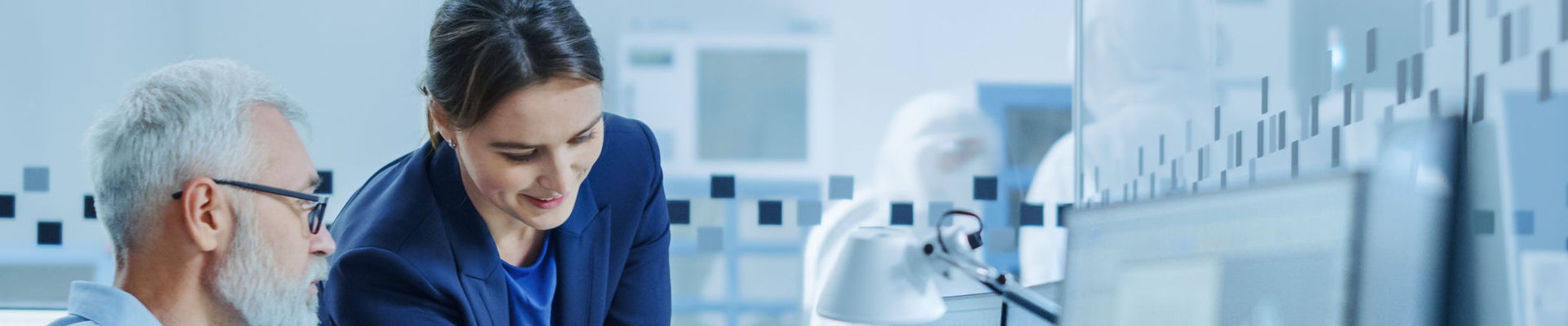 Inside Factory Office: Female Project Supervisor Talks to Male Senior Industrial Engineer who Works on Computer, Talk. In Workshop: Professional Workers Use High-Tech Industry CNC Machinery