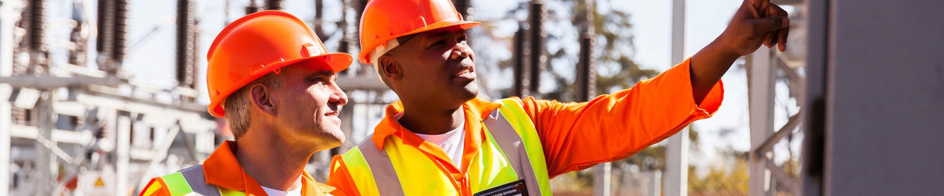 successful electrical engineers taking machine readings in substation