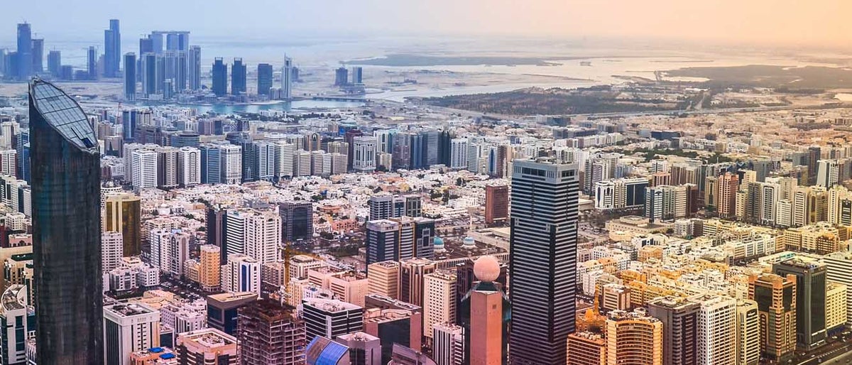 Panoramic sunset city skyline. Abu Dhabi attracts 10 million people annually.