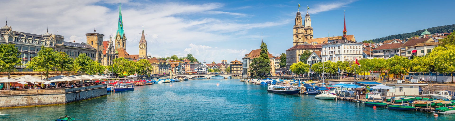 Panoramic view of historic Zurich city center with famous Fraumunster, Grossmunster and St. Peter and river Limmat at Lake Zurich on a sunny day with clouds in summer, Canton of Zurich, Switzerland