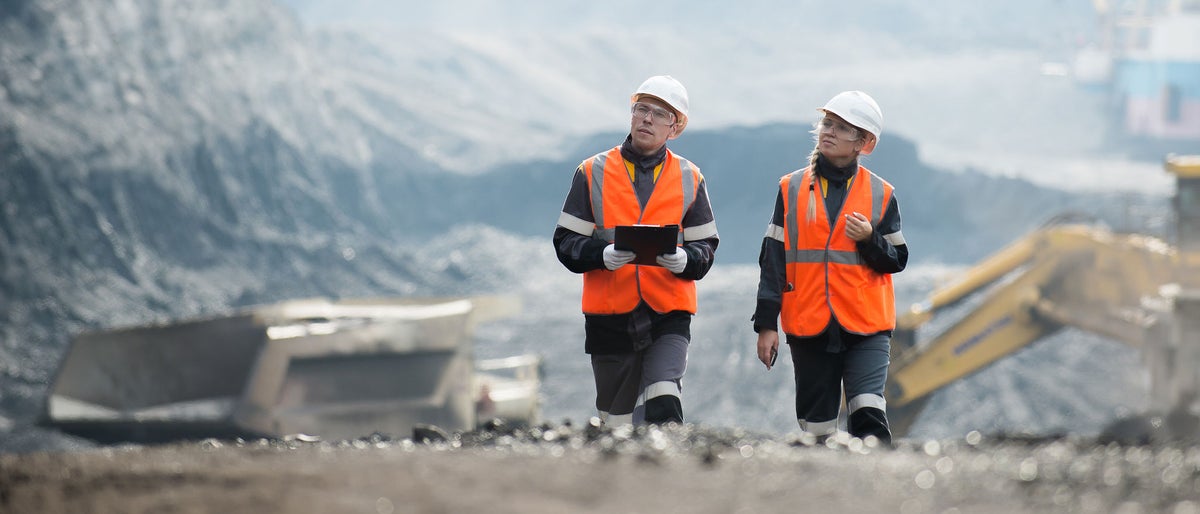 Workers with coal at open pit