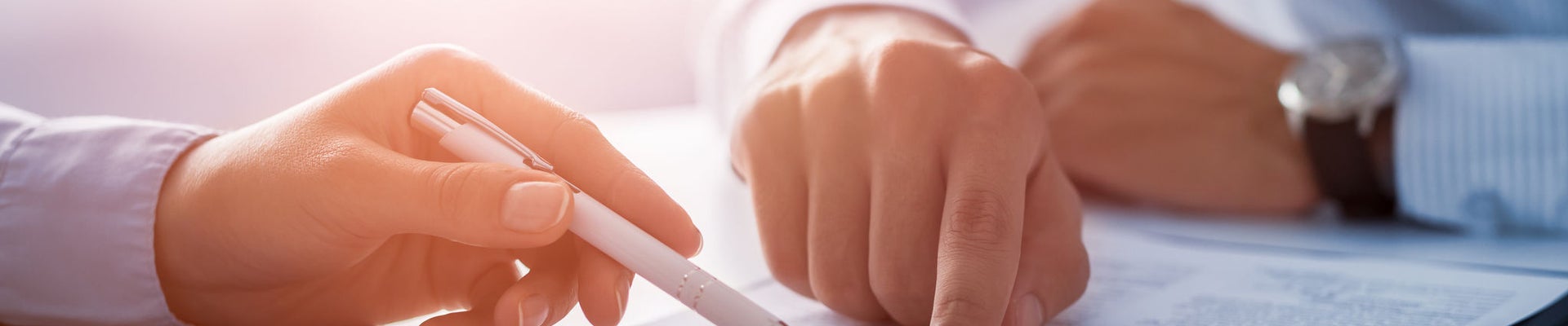 Business people negotiating a contract. Human hands working with documents at desk and signing contract.