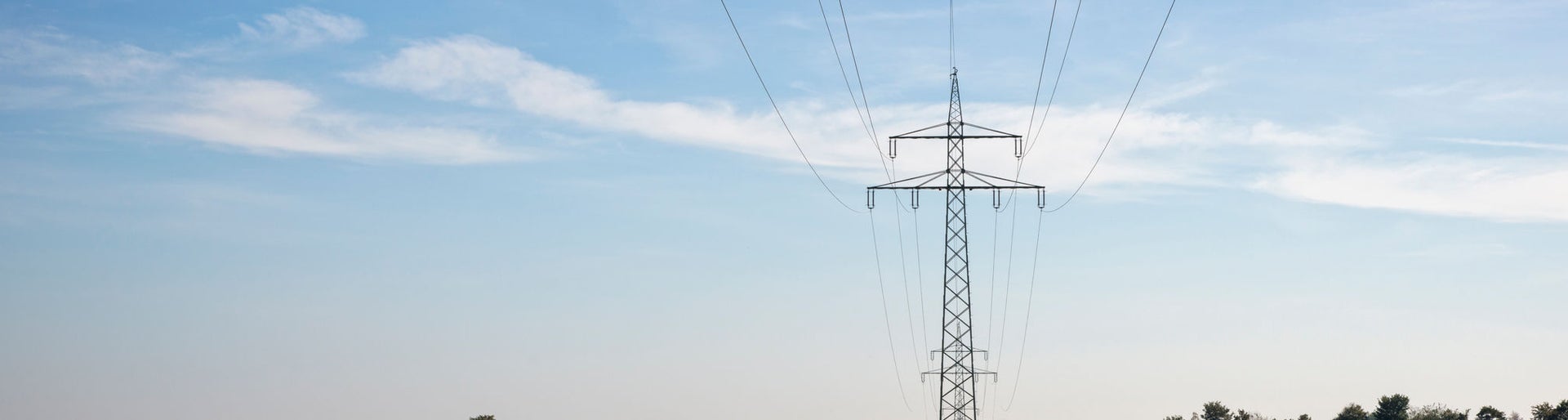Transmission towers and power lines in agricultural fields.
