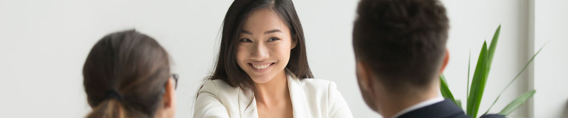 Happy millennial asian applicant getting hired shaking hand of hr, employer handshaking successful smiling chinese candidate congratulating with job interview win offering employment contract concept