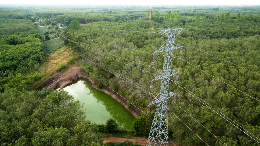 Aerial view of High voltage post or High voltage tower in forest