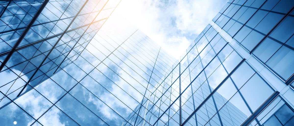 glass buildings with cloudy blue sky background