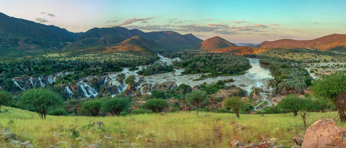 Epupa Falls full of water on the Kunene River, Northern Namibia and Angola border. Sunrise african landscape. Pure nature