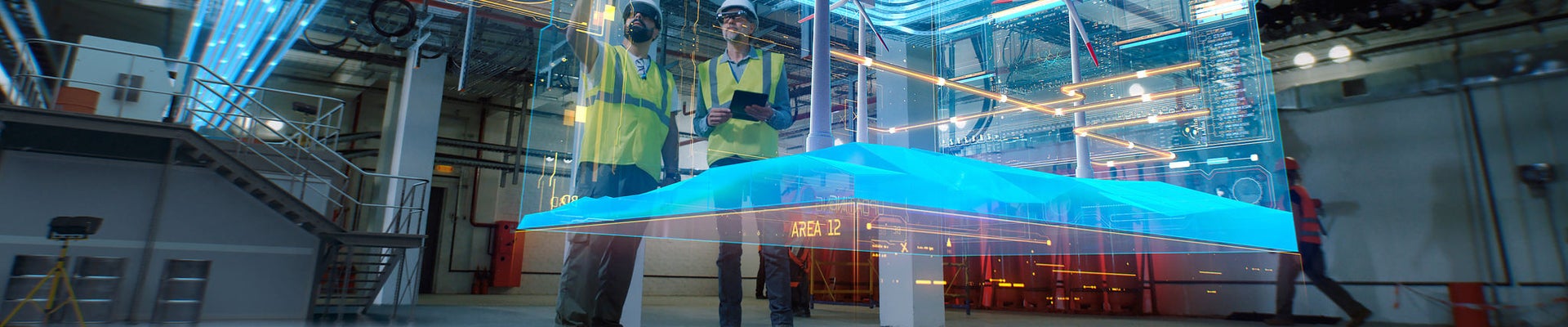 Low angle of male colleagues in vests and hardhats examining and discussing 3D plan of modern wind power station in workshop of factory