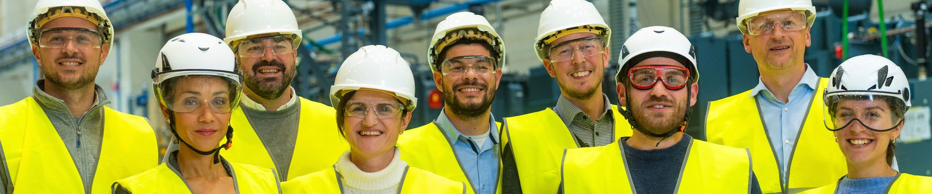 Young woman in an apron in a greenhouse conducts research into the growth of vegetables. Summer assignment for a student