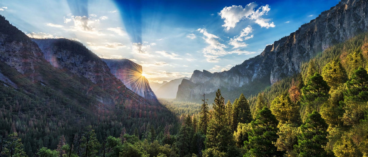 mountains with clouds and sunrise reflecting sustainable future