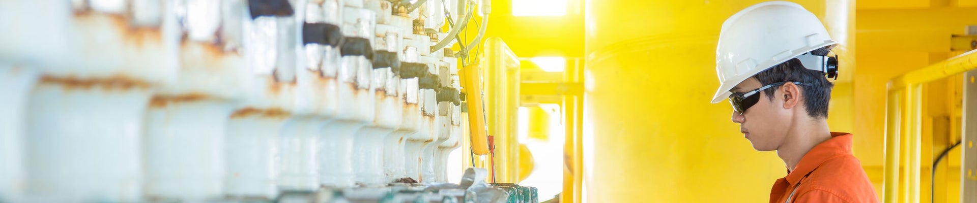 Electrical and instrument technician maintenance electric system at offshore oil and gas processing platform he using hand held calibrator an digital multi meter to calibrate choke valve.