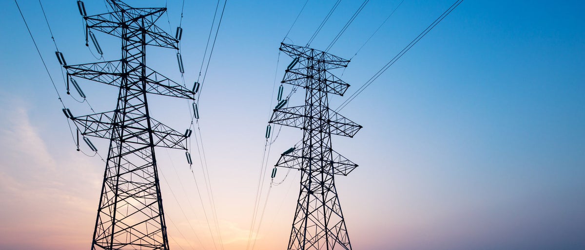 landscape of steel power tower in blue sky at sunrise