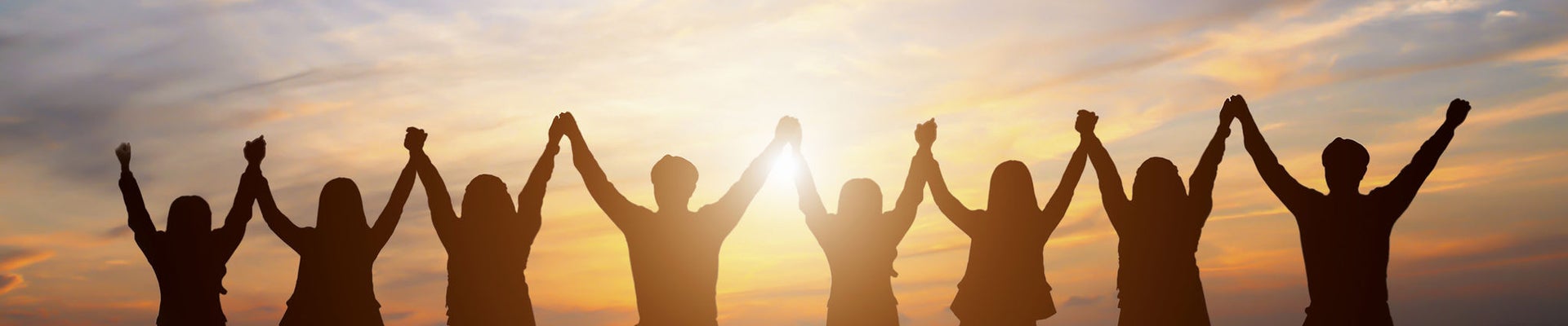 Silhouette of group happy business team making high hands over head in beautiful sunset sky evening time for business success and teamwork concept in company 