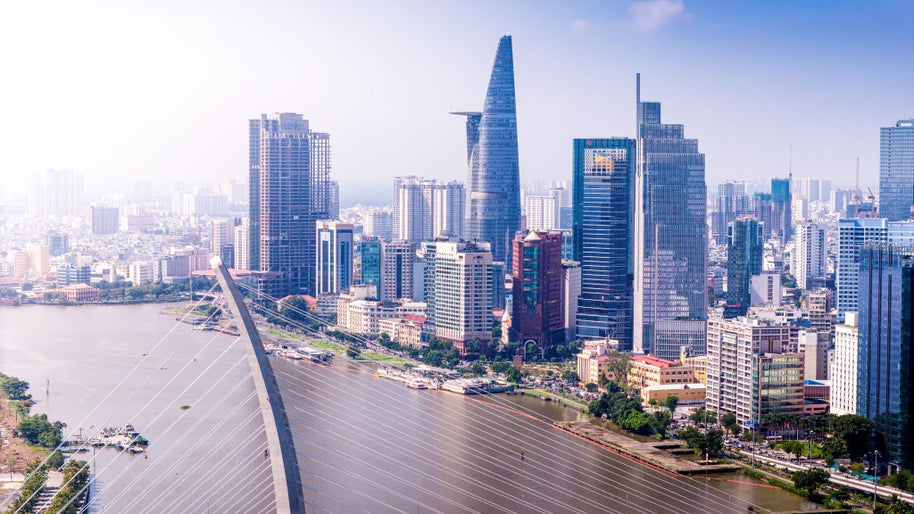 Aerial view of Ho Chi Minh city skyline with buildings, roads, bridge and Saigon river in Vietnam in the morning. Travel and business concept.