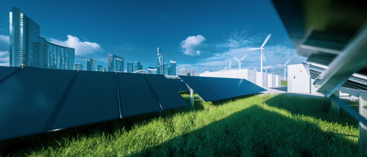 Modern black frameless solar panel farm, battery energy storage and wind turbines on fresh green grass under blue sky - concept of green sustainable energy  system. 3d rendering.