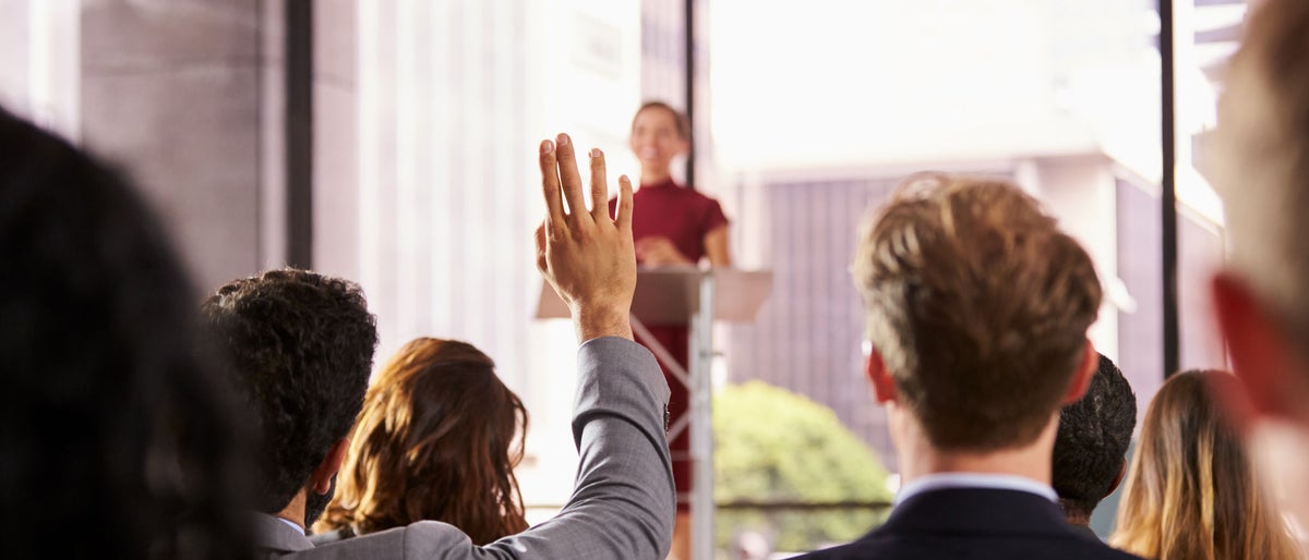 Presenter at business seminar takes a question from audience