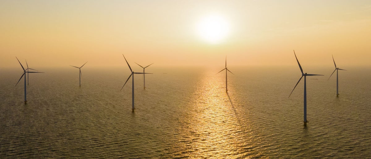 Offshore Windmill farm in the ocean Westermeerwind park, windmills isolated at sea on a beautiful bright day Netherlands Flevoland Noordoostpolder. Huge windmill turbines