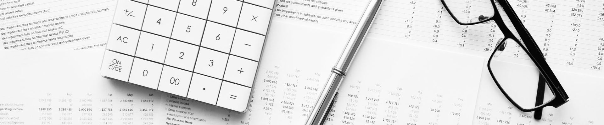 Calculator with pen on financial data. Concept of Business and Finance research .