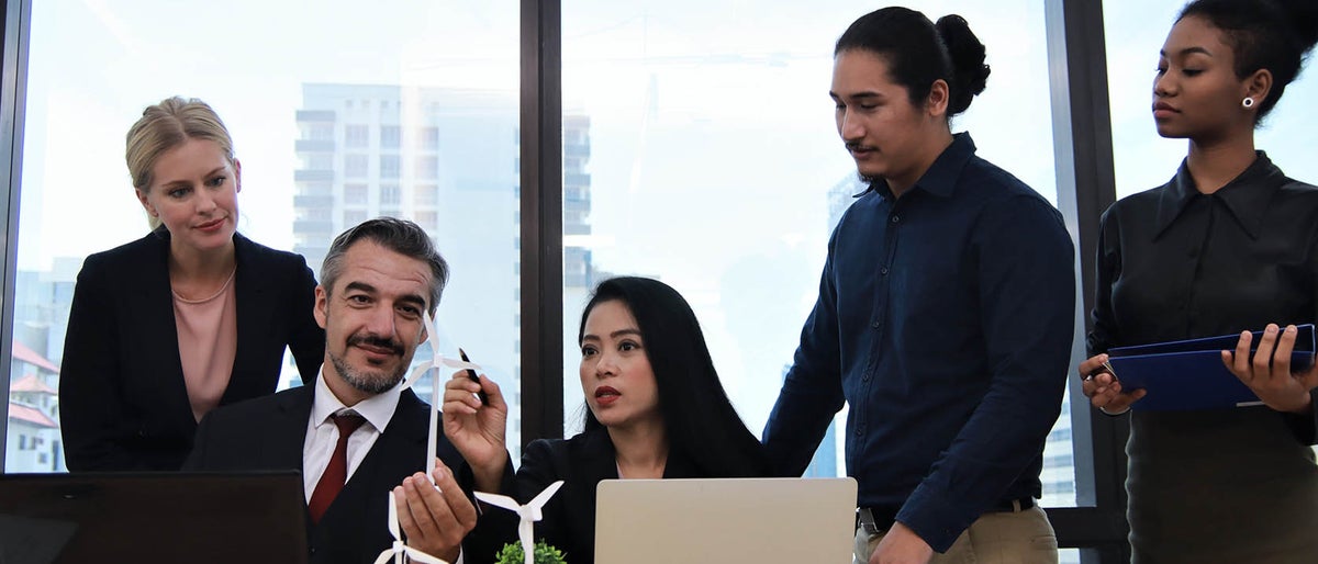 Business people meeting discussing about wind energy model project concept at multicultural office company concept with selective focus