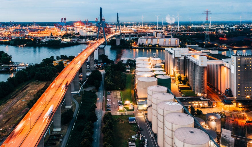 An illuminated power station, flyover and Hamburg docks